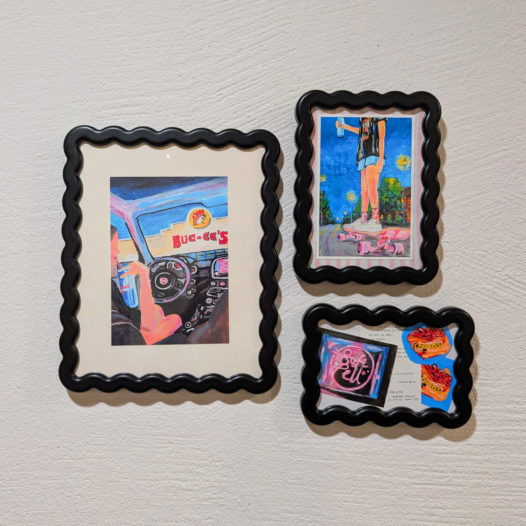 Four framed artworks on a textured wall