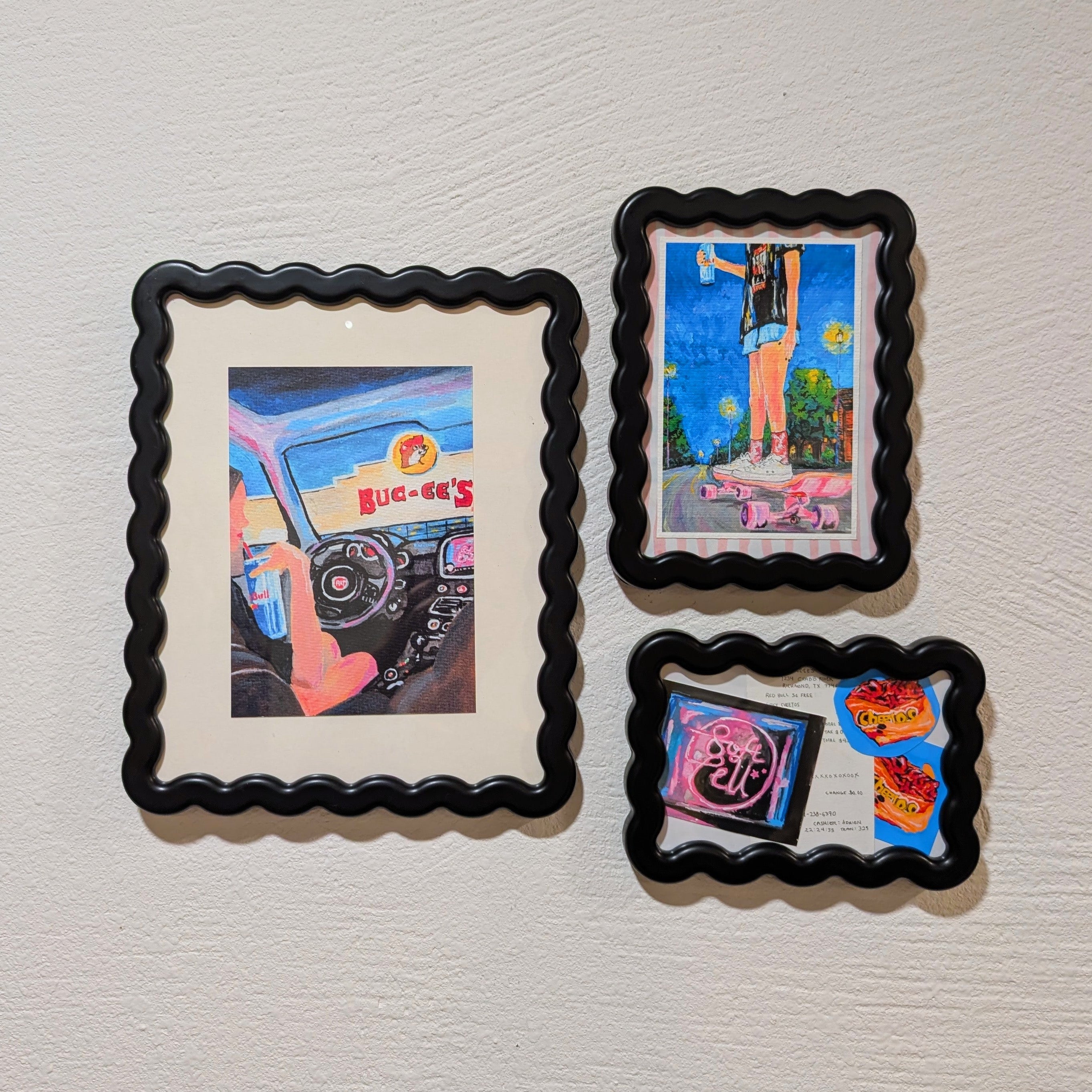 Four framed artworks on a textured wall